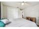 A well-lit bedroom includes luxury vinyl plank floors, a closet, and a ceiling fan at 4802 18Th St, Zephyrhills, FL 33542