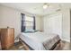 The bedroom features luxury vinyl plank floors, a ceiling fan and a closet for storing belongings at 4802 18Th St, Zephyrhills, FL 33542