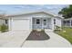 Charming home featuring a one-car garage, quaint porch with seating, and a well-manicured lawn at 4802 18Th St, Zephyrhills, FL 33542
