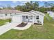 Exterior elevation features a manicured lawn, inviting porch, and attached garage at 4802 18Th St, Zephyrhills, FL 33542