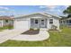 Charming home featuring a one-car garage, quaint porch with seating, and a well-manicured lawn at 4802 18Th St, Zephyrhills, FL 33542