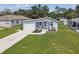 Lovely single-story home showcasing a lush front yard, driveway, and inviting front porch with chairs at 4802 18Th St, Zephyrhills, FL 33542