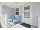 Charming front porch with light blue rocking chairs and a welcoming entrance door at 4802 18Th St, Zephyrhills, FL 33542
