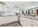 Well-lit kitchen with stainless steel appliances, granite countertops, and ample cabinet space at 4802 18Th St, Zephyrhills, FL 33542