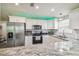 Bright kitchen with white cabinets, granite counters and stainless steel appliances at 4802 18Th St, Zephyrhills, FL 33542