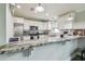 Bright kitchen features white cabinets, granite countertops, stainless steel appliances, and a breakfast bar at 4802 18Th St, Zephyrhills, FL 33542