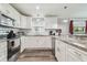 Well-lit kitchen with stainless steel appliances, granite countertops, and ample cabinet space at 4802 18Th St, Zephyrhills, FL 33542