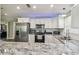 Well-lit kitchen with stainless steel appliances, white cabinets, granite countertops, and subway tile backsplash at 4802 18Th St, Zephyrhills, FL 33542