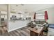 Open-concept living space featuring modern flooring, stainless steel appliances, and a cozy seating area at 4802 18Th St, Zephyrhills, FL 33542