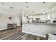 Open layout showcasing the kitchen, dining area, and living room with modern finishes and plenty of natural light at 4802 18Th St, Zephyrhills, FL 33542