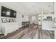 Inviting living room with new flooring, a large TV, a dining area, and an open layout at 4802 18Th St, Zephyrhills, FL 33542