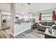 Open living room and kitchen area with a gray sofa, breakfast bar, and stainless steel appliances at 4802 18Th St, Zephyrhills, FL 33542