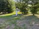 Backyard with well pump system surrounded by greenery and grass at 502 Johnson Rd, Plant City, FL 33566