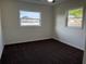 Bright bedroom featuring plush carpeting and natural light from two large windows at 502 Johnson Rd, Plant City, FL 33566