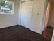 Bedroom showing built-in closet and doorway, with carpeting and neutral-colored walls at 502 Johnson Rd, Plant City, FL 33566