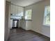 Bright kitchen with stainless steel dishwasher, white cabinets, and granite countertops; a blend of style and function at 502 Johnson Rd, Plant City, FL 33566