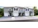 Modern townhomes feature an attached garage and welcoming entrances, combining style and functionality at 5110 Captain Davis Dr, Wimauma, FL 33598