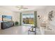 Inviting living room featuring stylish decor and sliding glass doors, perfect for entertaining at 5112 Captain Davis Dr, Wimauma, FL 33598