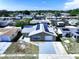 A high aerial view showcasing a home with solar panels, a garage, and a beautiful neighborhood setting at 5139 Victoria Ln, Holiday, FL 34690
