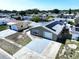 Aerial view of a charming home with solar panels, well-kept lawn, a one-car garage, and neighborhood at 5139 Victoria Ln, Holiday, FL 34690