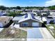 A high aerial view showcasing a home with solar panels, a garage, and a beautiful neighborhood setting at 5139 Victoria Ln, Holiday, FL 34690