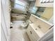 Modern bathroom with accessible shower, safety bars, and updated vanity and lighting fixtures at 5139 Victoria Ln, Holiday, FL 34690