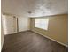A simple bedroom with natural light, closet, and neutral wall color at 5139 Victoria Ln, Holiday, FL 34690