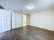 Spacious bedroom featuring wood-look floors, closet, and an ensuite bathroom for added privacy and convenience at 5139 Victoria Ln, Holiday, FL 34690