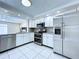 Well-equipped kitchen with stainless steel appliances, granite countertops, and ample storage space at 5139 Victoria Ln, Holiday, FL 34690
