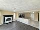Open-concept living room with a fireplace and views into the kitchen at 5139 Victoria Ln, Holiday, FL 34690