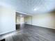 Large living room featuring gray vinyl floors, neutral paint, and modern lighting fixtures at 5139 Victoria Ln, Holiday, FL 34690