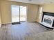 Inviting living room with sliding glass door, vinyl flooring, and a fireplace for a warm ambiance at 5139 Victoria Ln, Holiday, FL 34690