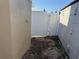 View of side yard with a white fence and storage unit at 5139 Victoria Ln, Holiday, FL 34690