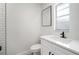 Modern bathroom featuring black fixtures, a vanity, and a frosted window at 5405 S Sellas St, Tampa, FL 33611