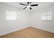 Bright bedroom featuring a ceiling fan and natural light from two windows at 5405 S Sellas St, Tampa, FL 33611