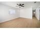 Spacious bedroom with wood-look floors, ceiling fan, and ample natural light at 5405 S Sellas St, Tampa, FL 33611