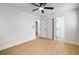 Bright bedroom featuring wood-look floors, ceiling fan, and neutral walls at 5405 S Sellas St, Tampa, FL 33611