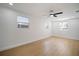 Spacious bedroom with hardwood floors, neutral paint, multiple windows, and ceiling fan at 5405 S Sellas St, Tampa, FL 33611