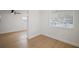 Bright bedroom features wood-look flooring, window with blinds, and a ceiling fan at 5405 S Sellas St, Tampa, FL 33611