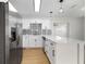 Modern kitchen features white cabinets, stainless steel appliances, black hardware, and a stylish backsplash at 5405 S Sellas St, Tampa, FL 33611