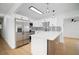 Kitchen showcasing white cabinets, stainless steel appliances, a stylish backsplash, and an island with modern accents at 5405 S Sellas St, Tampa, FL 33611