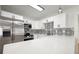 Bright kitchen featuring stainless steel appliances, white cabinets, black hardware and patterned backsplash at 5405 S Sellas St, Tampa, FL 33611