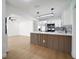 Modern kitchen with stainless steel appliances, white cabinets, and a decorative wood slat island at 5405 S Sellas St, Tampa, FL 33611