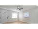 Bright living room with new floors, a ceiling fan, and a front door with decorative glass at 5405 S Sellas St, Tampa, FL 33611