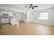 Open concept living room with hardwood floors, neutral paint, and direct access to kitchen at 5405 S Sellas St, Tampa, FL 33611