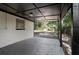 Enclosed patio area with view of the backyard and lush greenery at 5405 S Sellas St, Tampa, FL 33611