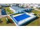 Aerial view of the covered community pool with surrounding homes and landscaping at 5409 Antigua Dr, Zephyrhills, FL 33541