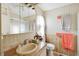 Functional bathroom featuring a practical vanity, toilet, and tiled shower stall at 5409 Antigua Dr, Zephyrhills, FL 33541