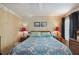 Comfortable bedroom featuring a patterned quilt and matching bedside lamps at 5409 Antigua Dr, Zephyrhills, FL 33541