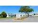 Oaks Royal 55+ senior park entrance with sign, landscaping, and community buildings at 5409 Antigua Dr, Zephyrhills, FL 33541